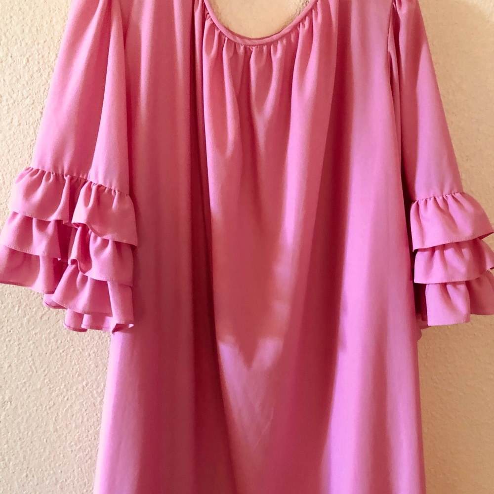 Sale! 60s vibe puts you “in the pink”. Ruffles on sleeves and hem.